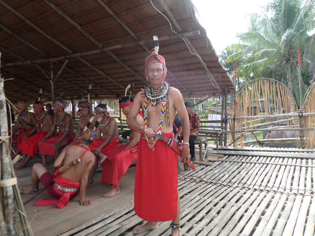 Dayak man in traditional costume in Sebujit