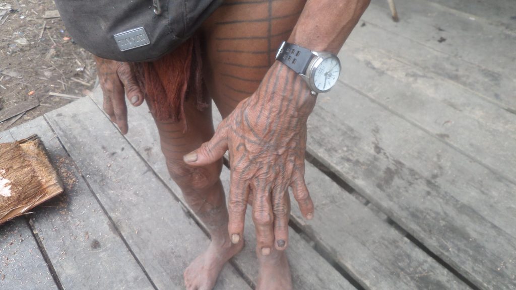 Mentawai shaman showing his tattoo