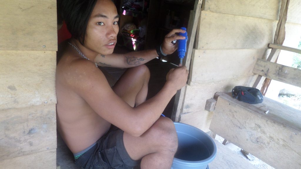 A Mentawai young man with his water purifier
