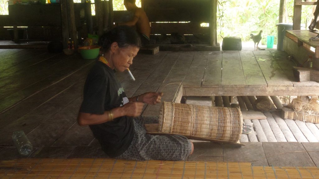 Mentawai woman making a basket