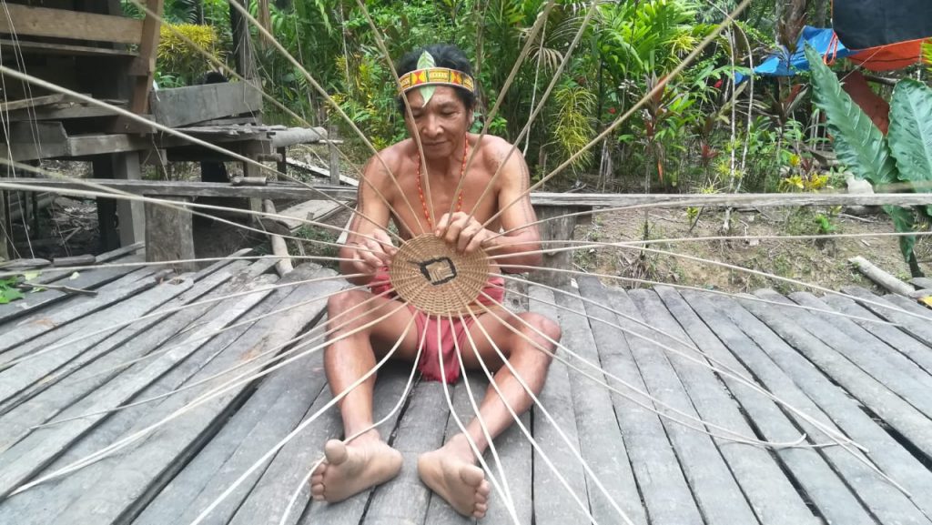 Mentawai man making a basket